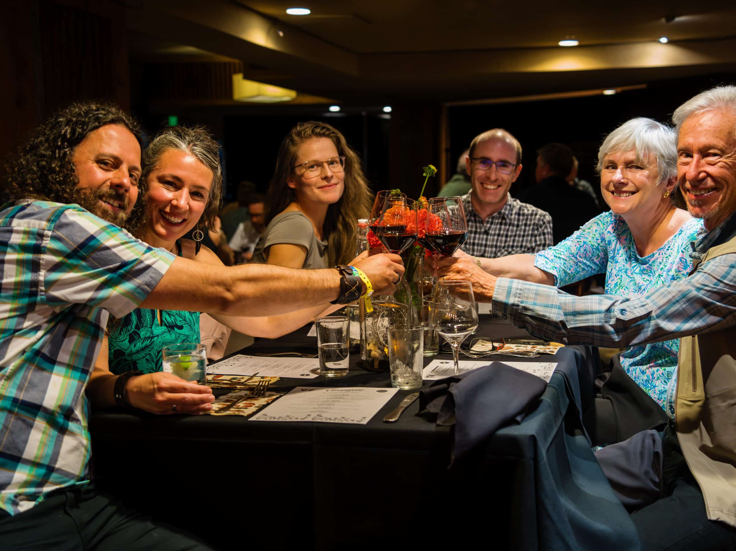 Friends cheers over their table at the Mushroom Dinner