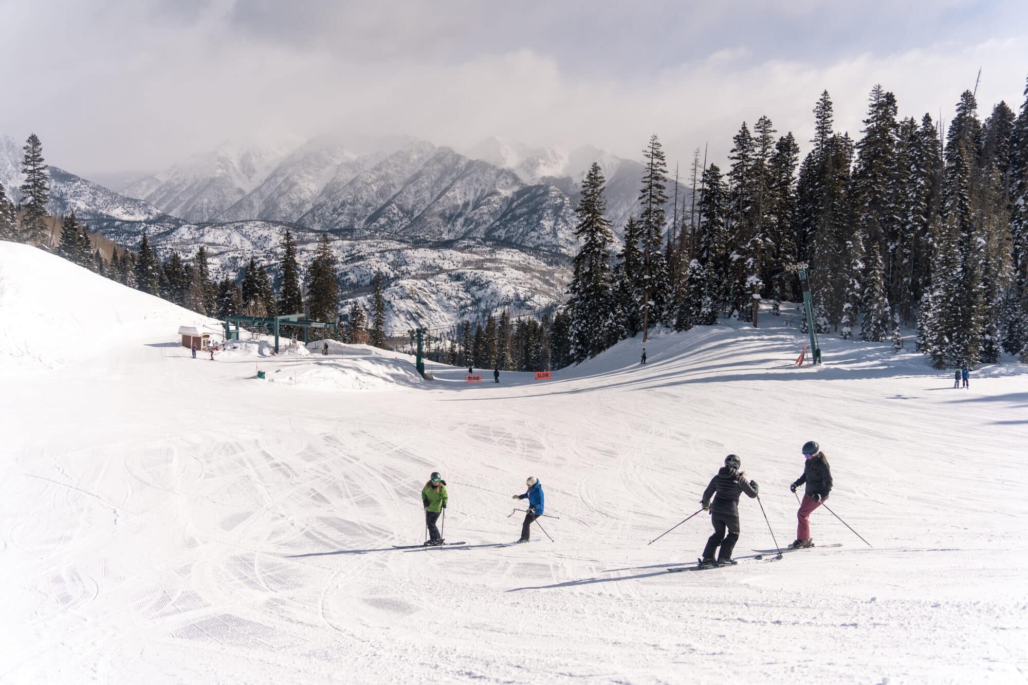 Adult ski clinic skis together working on edge control