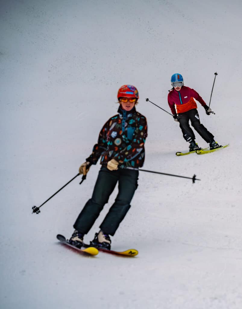 Skiers ride down the slopes on opening day