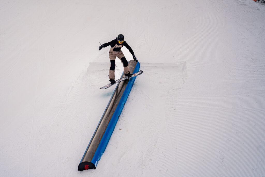 A snowboarder rides a rail in the Headwaters Terrain Park on opening day 