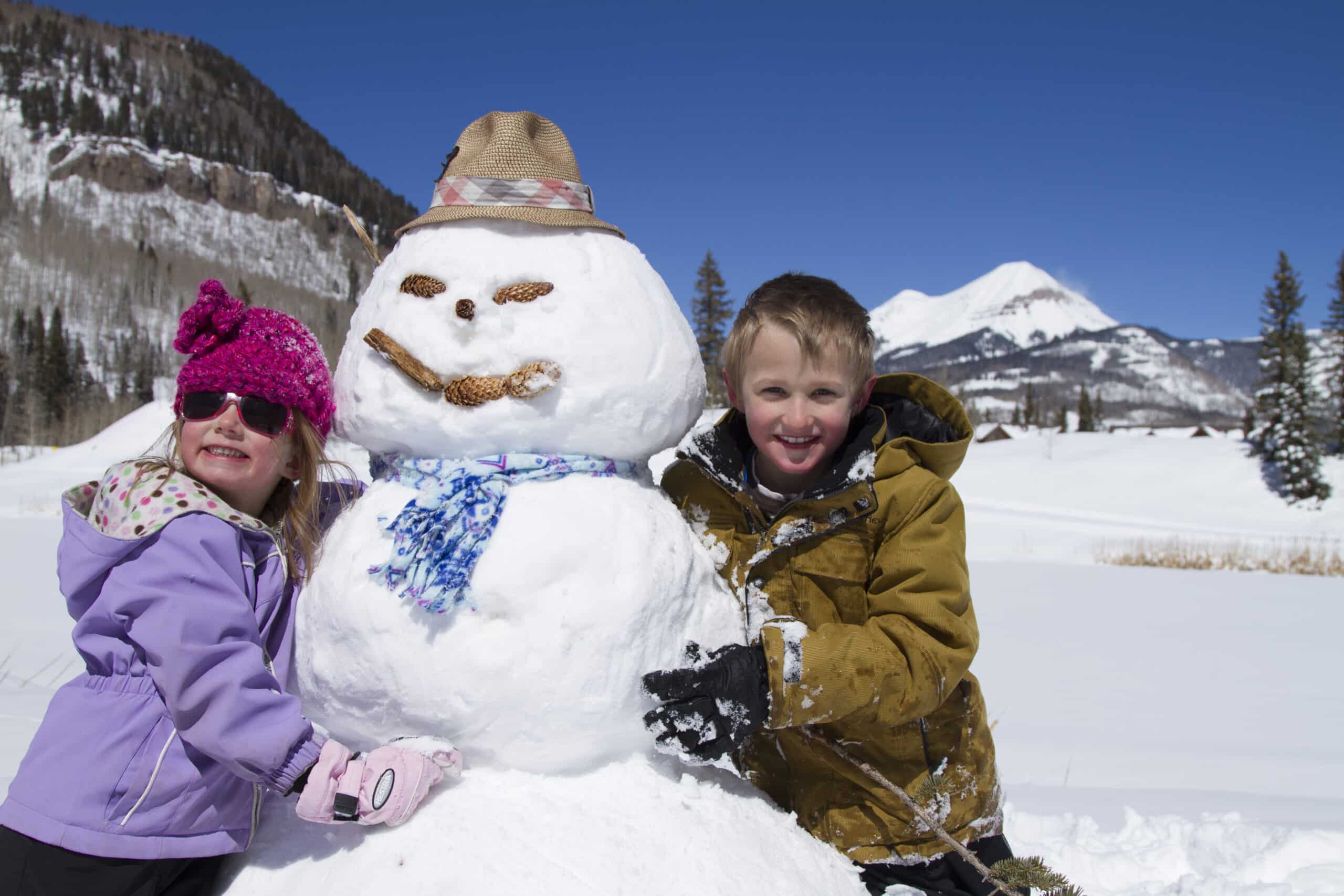 Kids build a snowman at Purgatory Resort