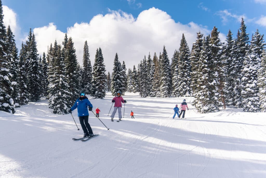 Group follows ski instructor down mountain at Purgatory Resort
