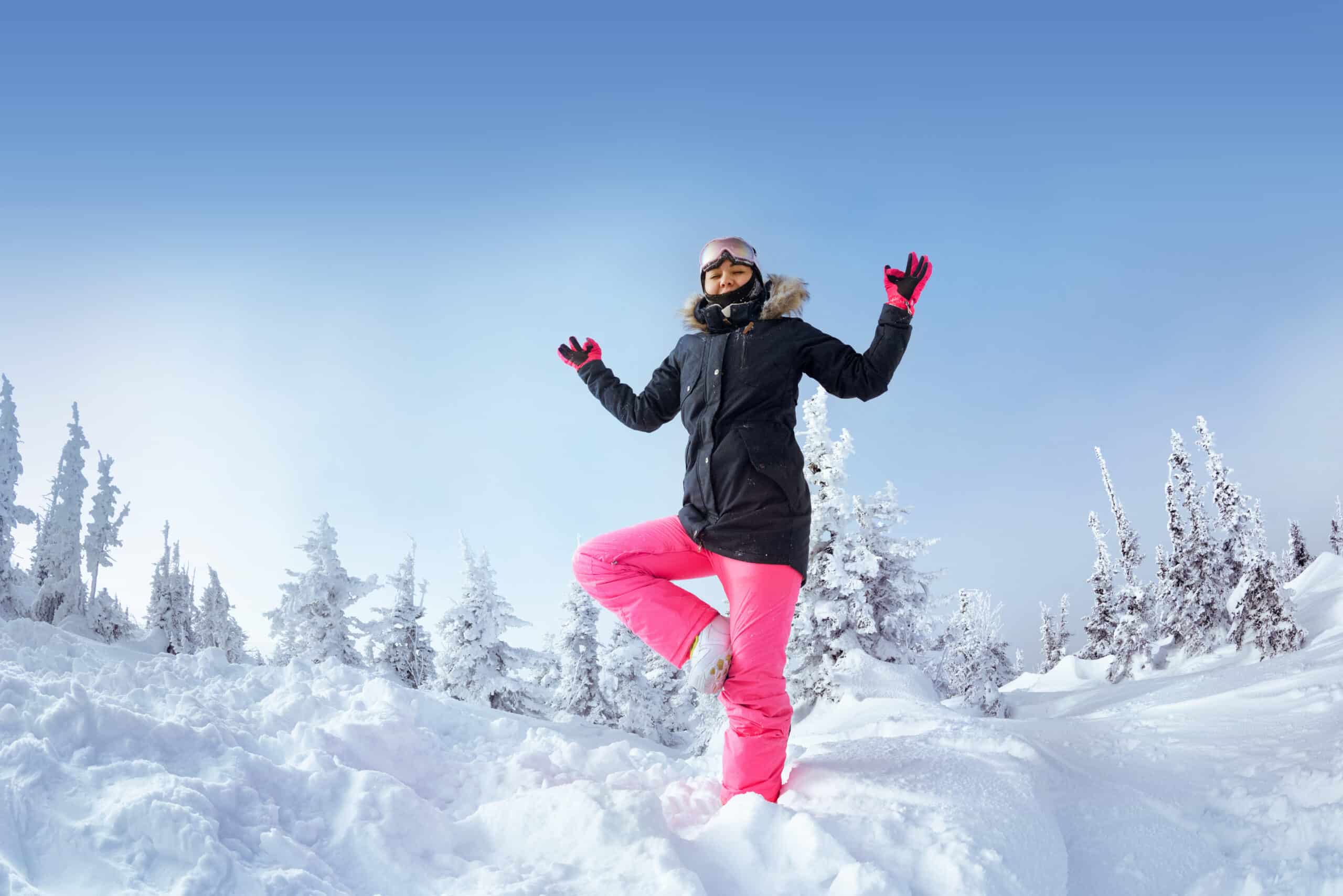 a skier does yoga in the snow