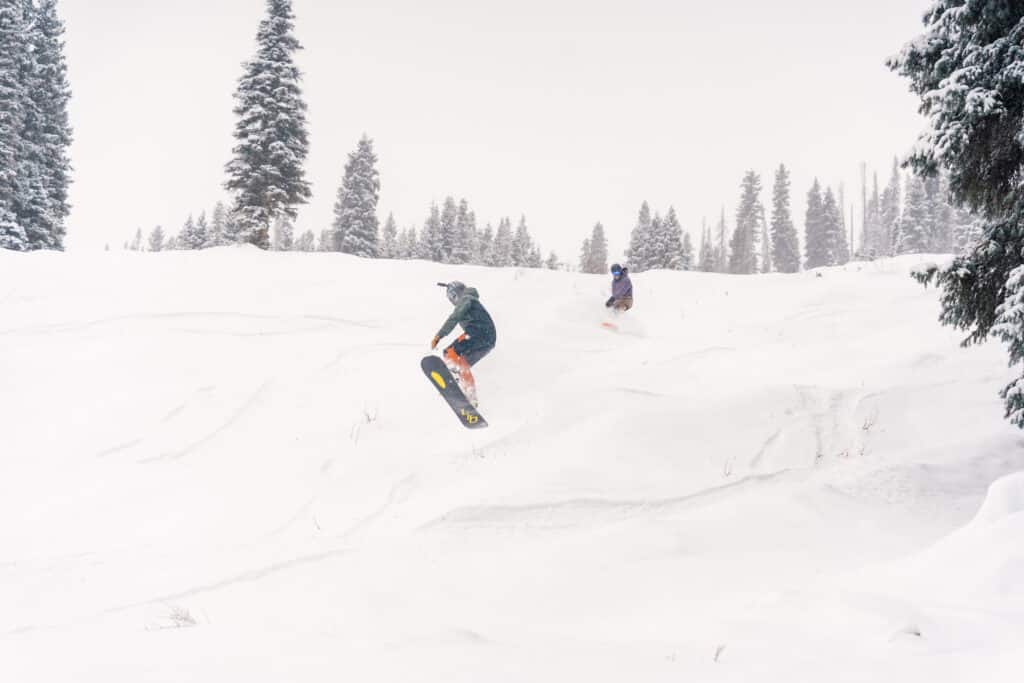 Groups rides down a powder covered slope