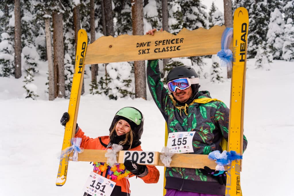 people cary a wooden frame that reads Dave Spencer Ski Classic 2023