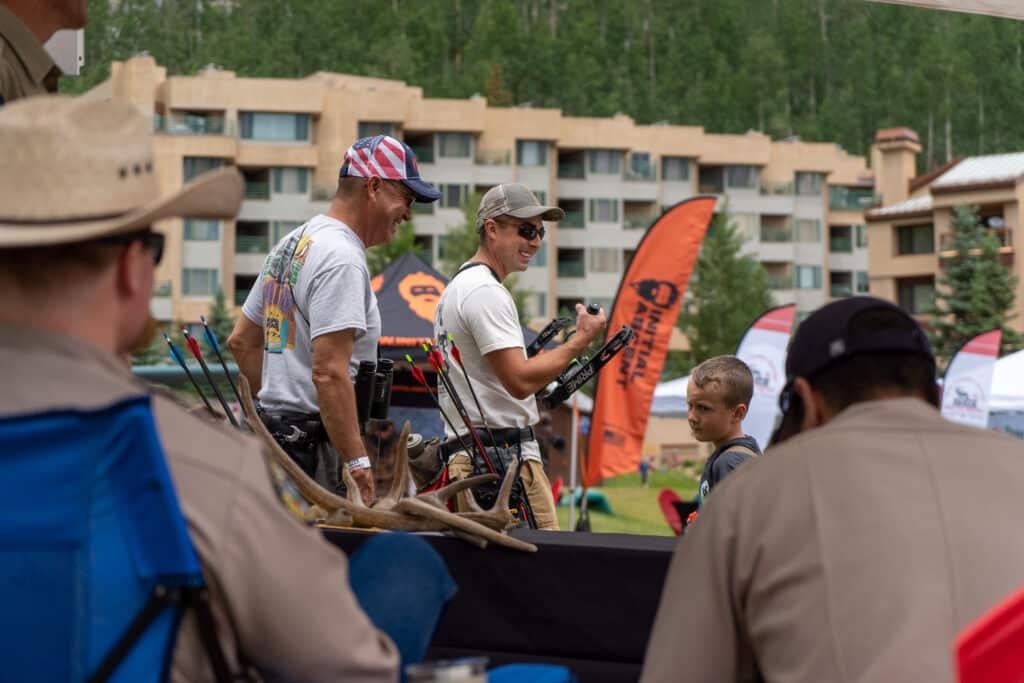 people mingle in the base area with their bow and arrows for mountain archery fest