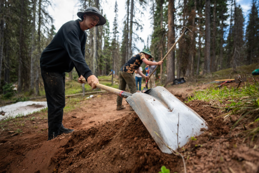 Purg Parks crew works with hand tools to maintain bike trails