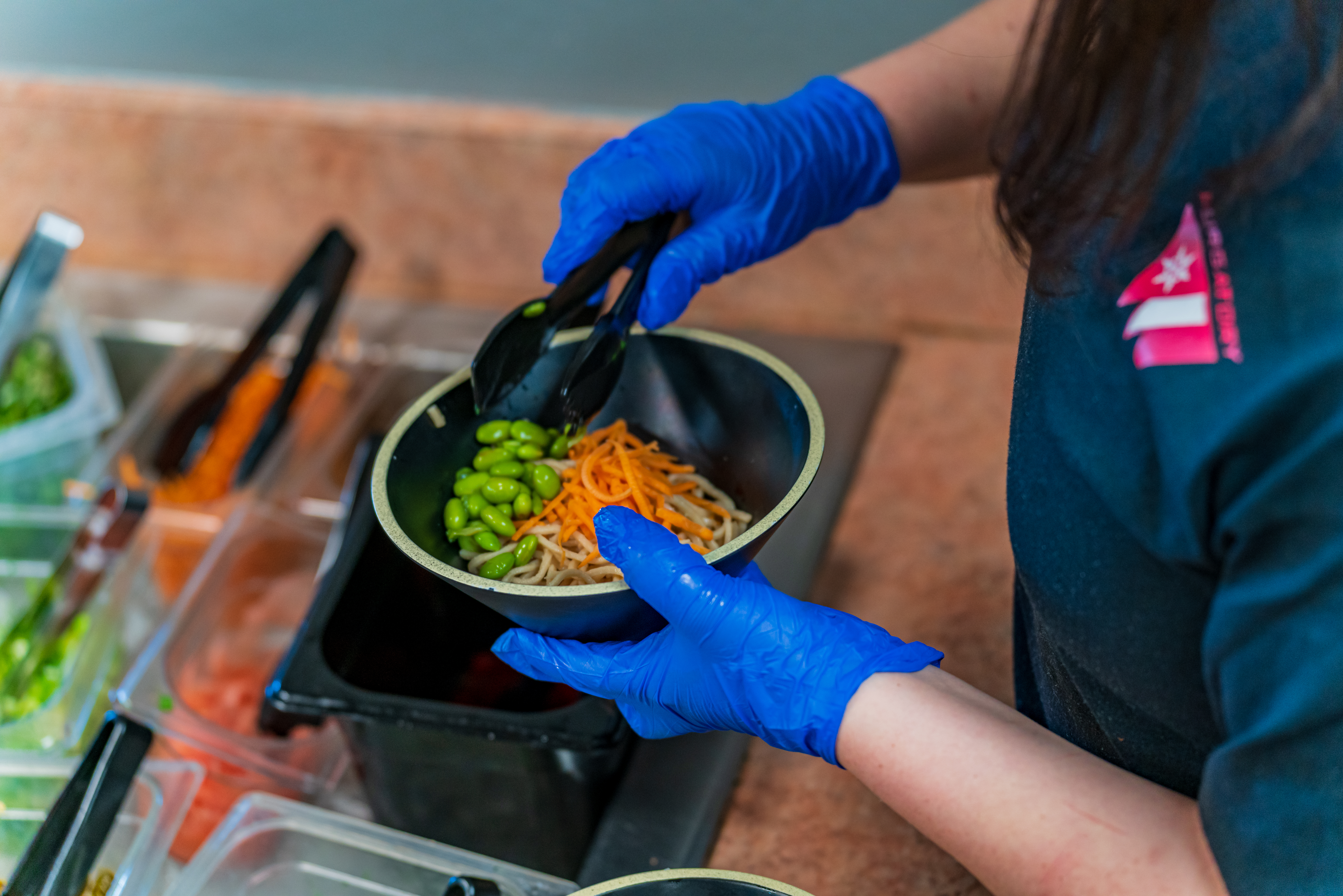 A staff member at Dante's prepares and ramen bowl at Purgatory Resort
