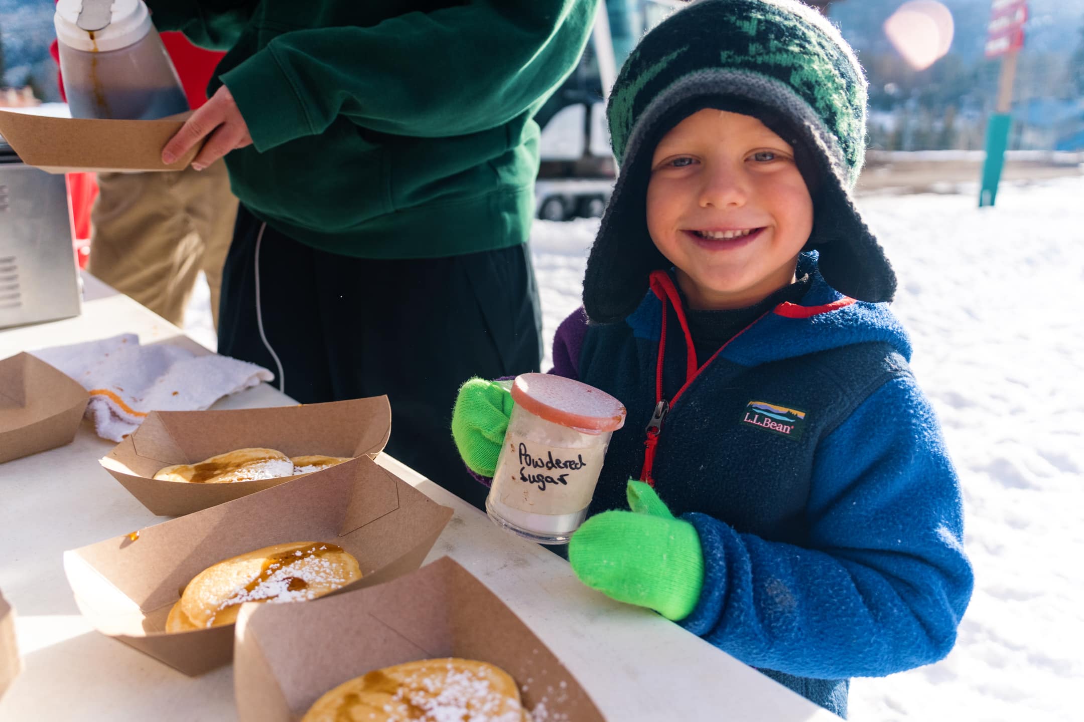 Adorable kid powders pancakes for opening day