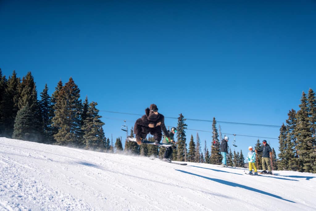 Bigfoot jumps on a snowboard