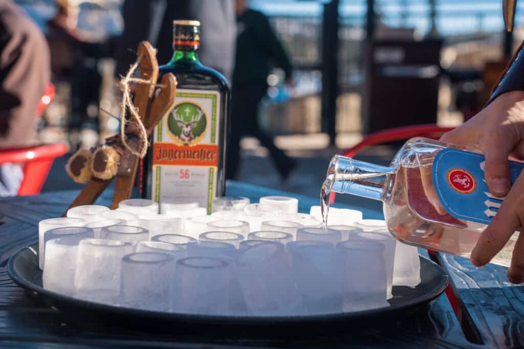 Jager is poured into shot glasses of ice