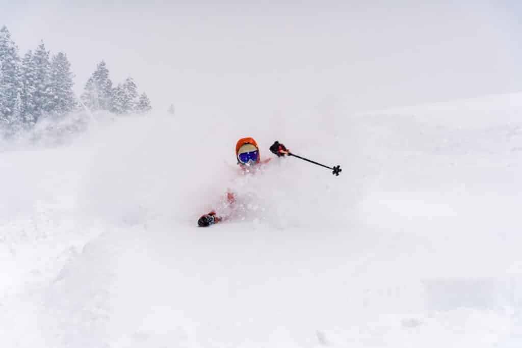 skiers rips through fresh powder