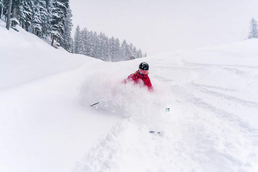 Skier in pink shreds fresh pow