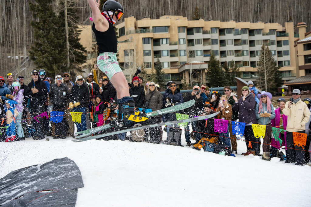 Skier pulls a spread eagle exiting the pond skim at Purgatory Resort
