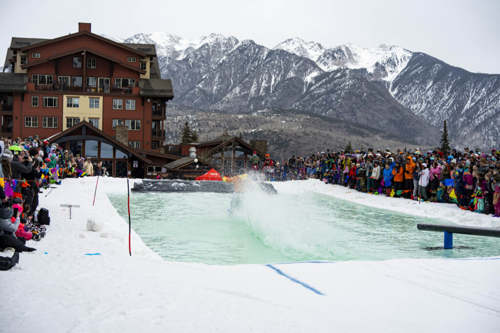 Needles mountain range covered in a fresh coat with the Purgatory Pond skim in the foreground