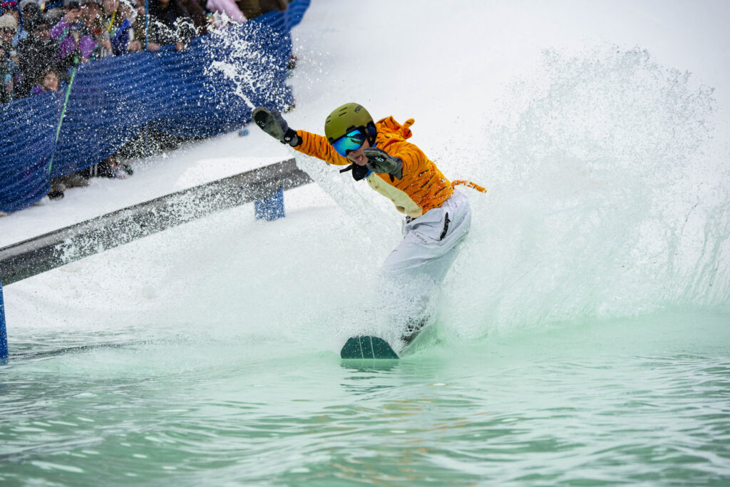 Young snowboarder in tiger outfit skims across the pond at Purgatory Resort