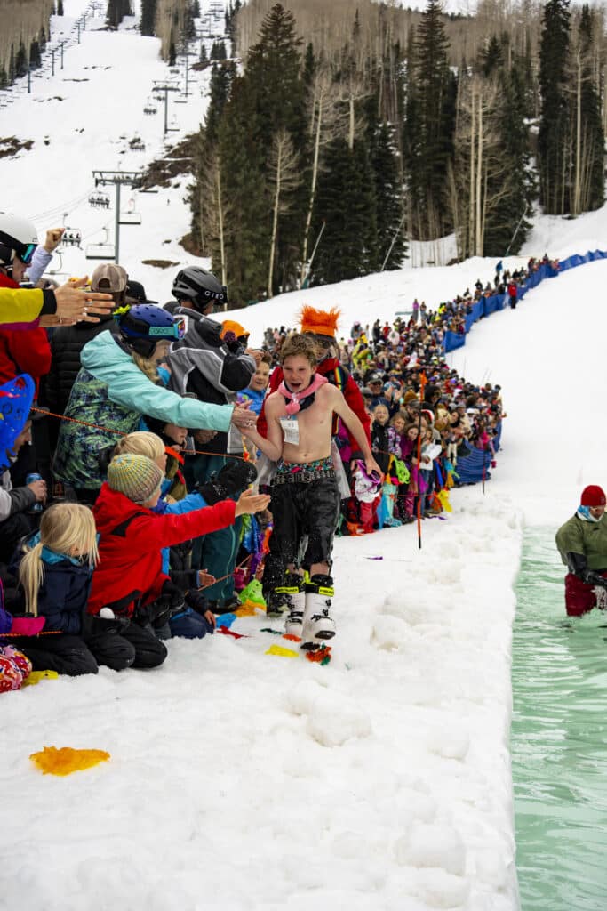 Kid high fives a crowd at pond skim