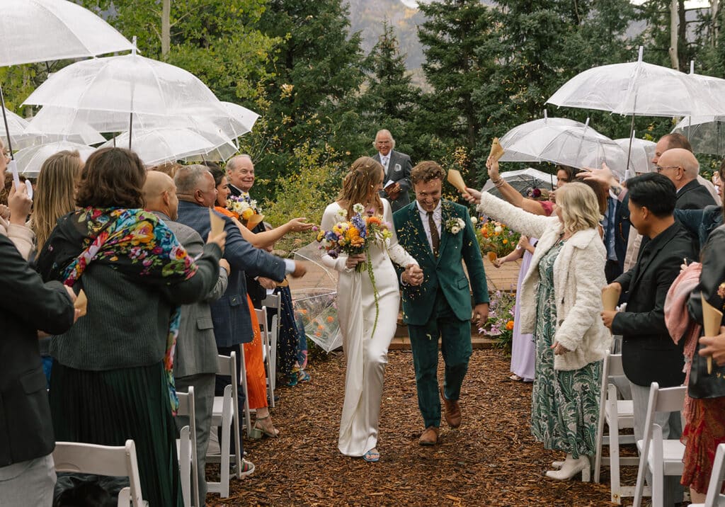 bride and groom celebrate down the aisle after their ceremony
