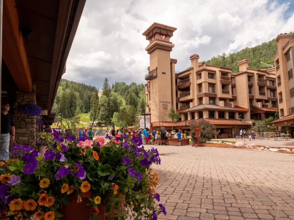 A view across the plaza of Village Center with blooming flowers in the foreground