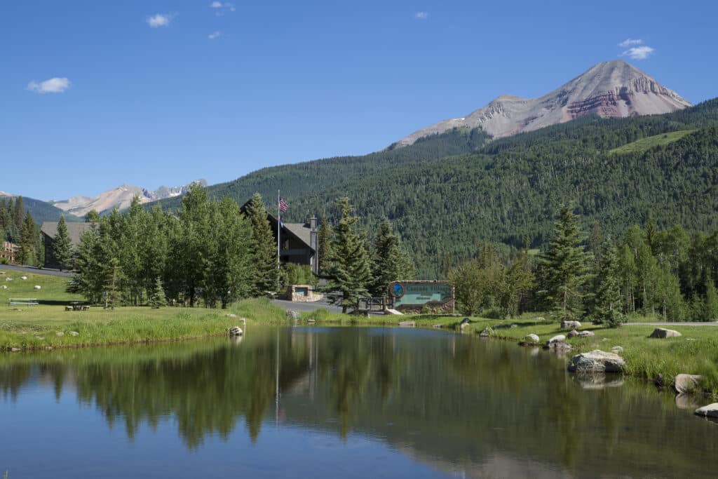 A view of entrance to peaceful Cascade Village across the pond with Engineer Mountain in the background