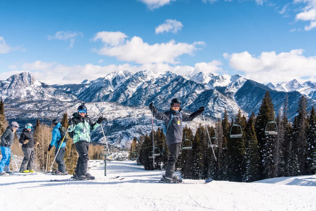 Group of skiers pause to celebrate the incredible snow and breathtaking views at Purgatory Resort