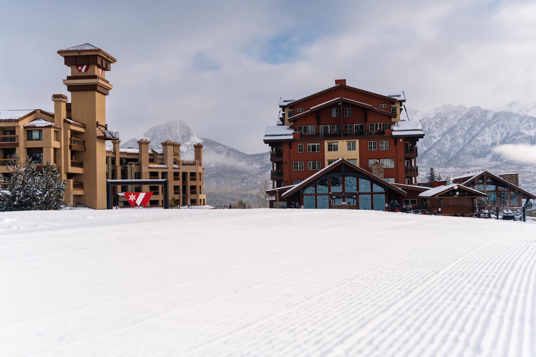 Perfect groom looking at the base area lodging of Purgatory Resort in November