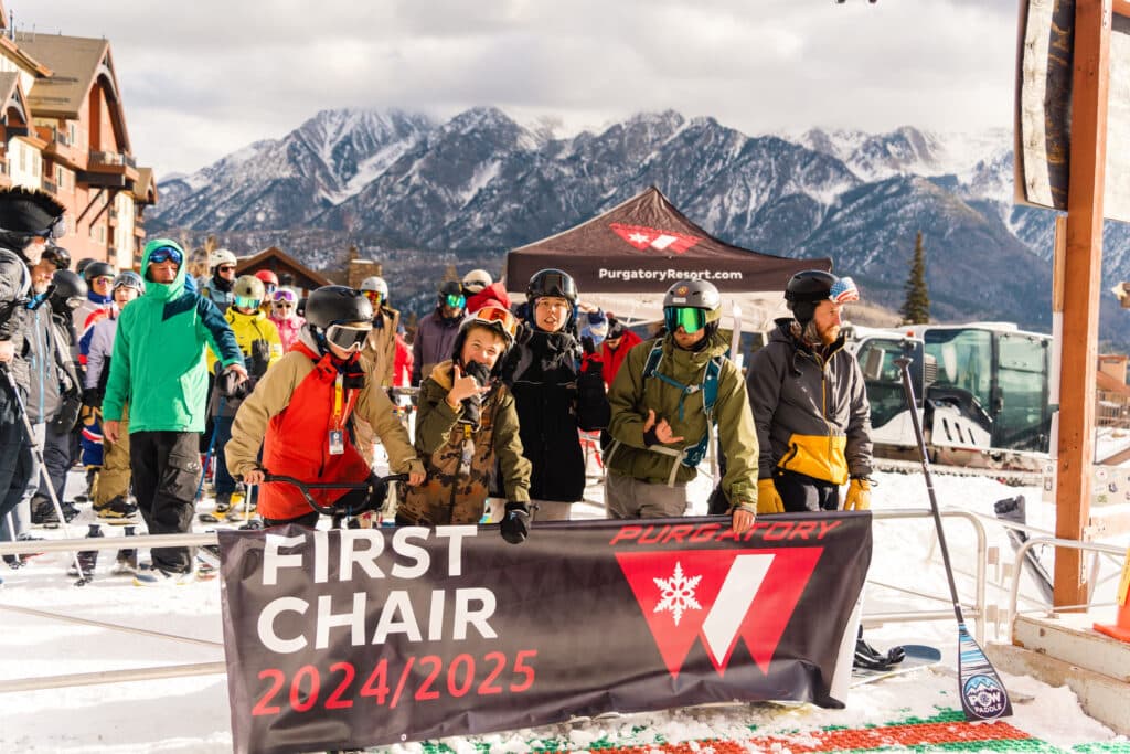 Group of happy skiers and boarders who claimed first chair for Purgatory's 24/25 season