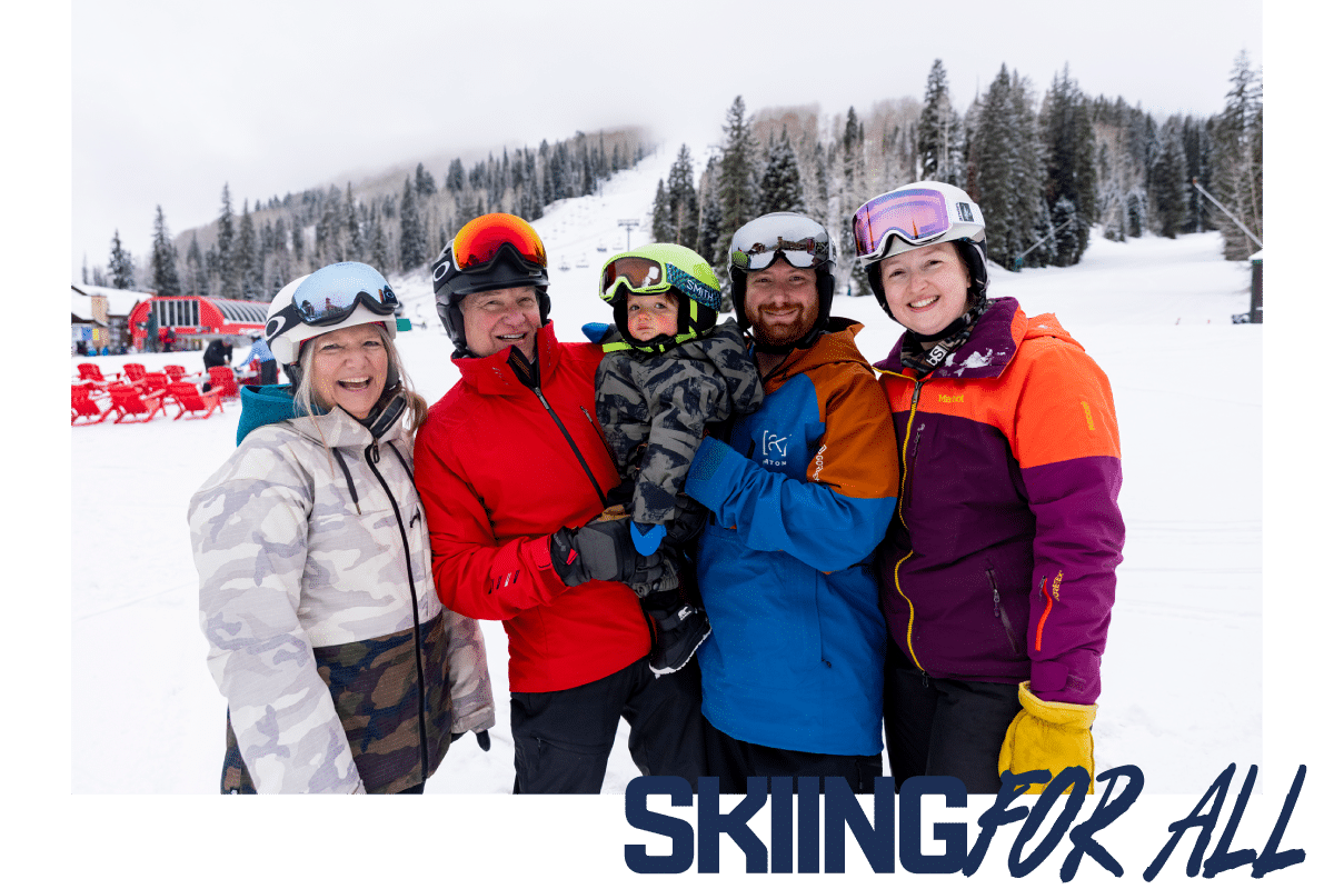 A family of 3 generations smiles for the camera at the beach area of Purgatory Resort