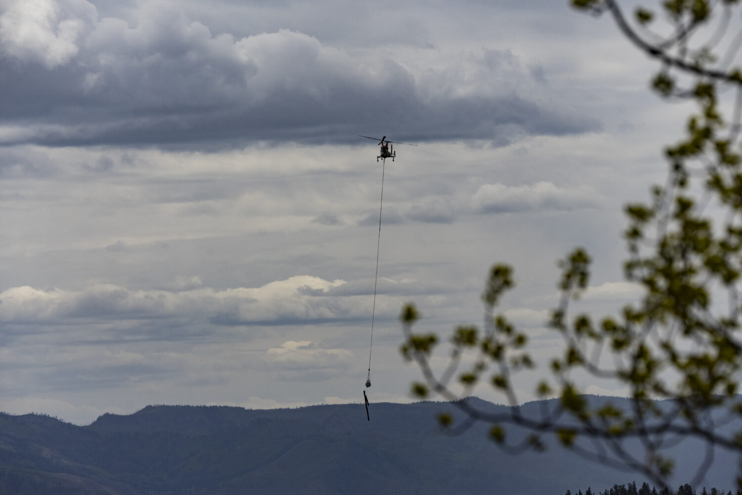 Helicopter carrying logs out of the Gelande lift project at Purgatory Resort