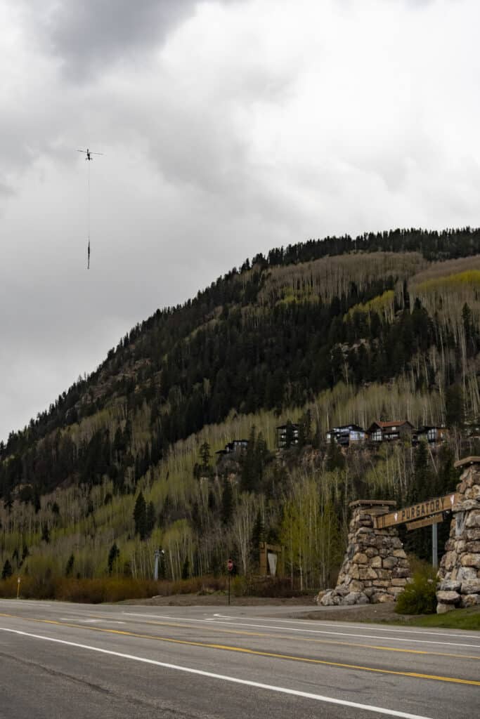 Helicopter carrying logs out of the Gelande lift project at Purgatory Resort