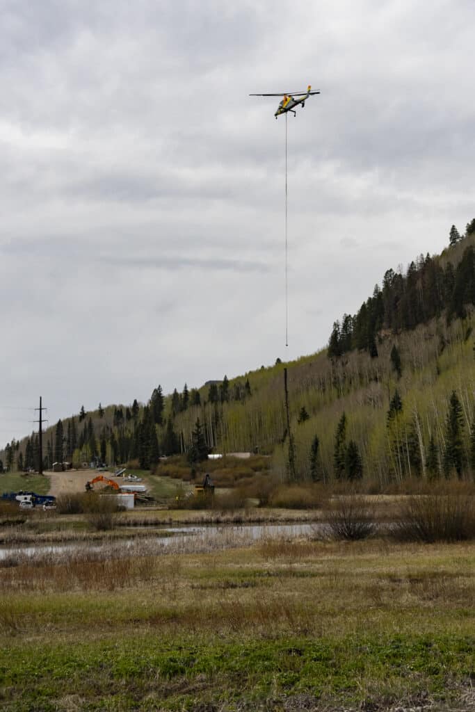 Helicopter carrying logs out of the Gelande lift project at Purgatory Resort