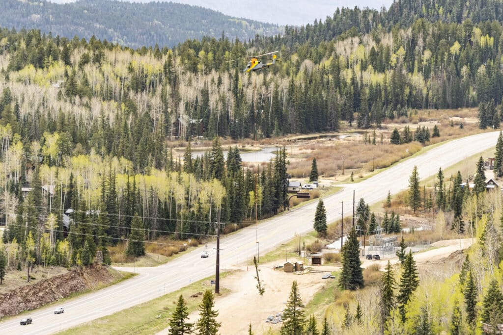 Helicopter carrying logs out of the Gelande lift project at Purgatory Resort