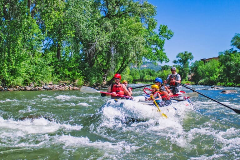 Group enjoys a guided raft trip by Mild 2 Wild down the Animas running through Durango, Colorado.