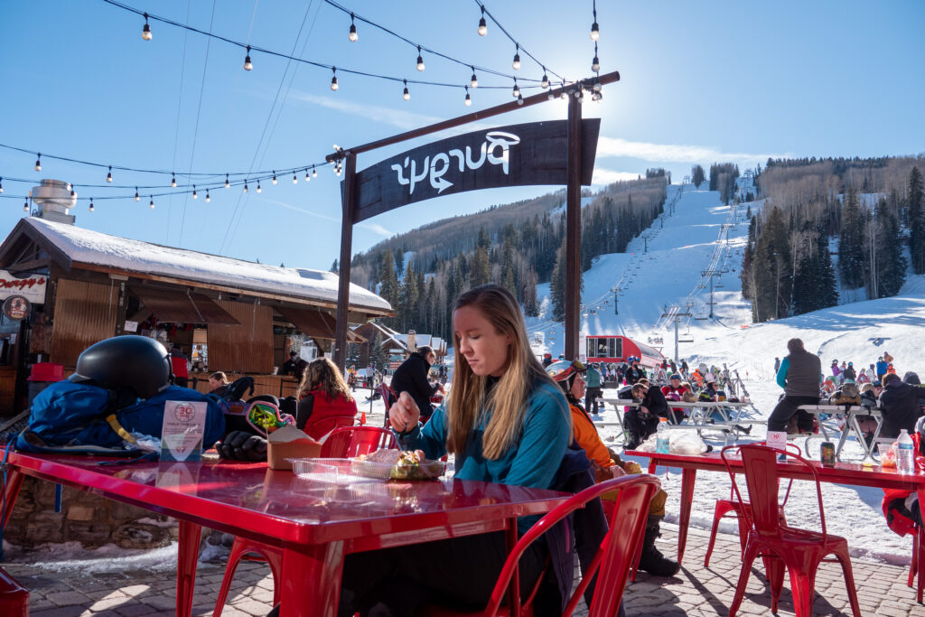 Female enjoys a meal outside on the Purgy's Patio on a bluebird day
