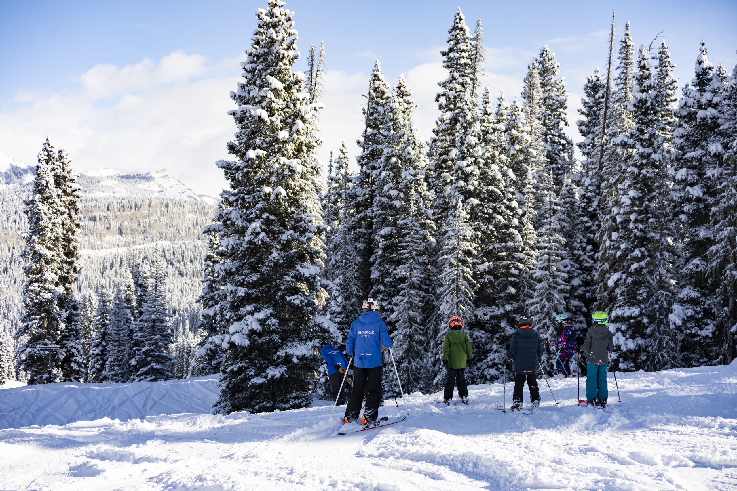 Ski instructors and a youth group stop at a headwall to check out the trail at Purgatory Resort